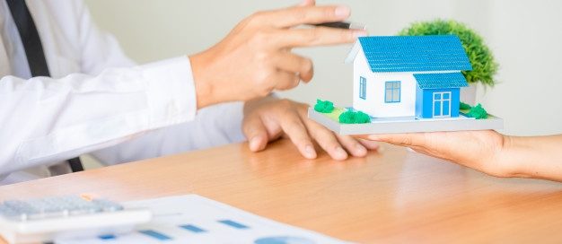 Landlord handing over house keys while discussing eviction and notice requirements for termination without cause in Texas.