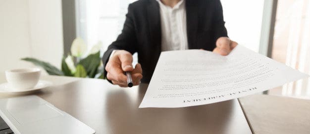 Landlord handing over an eviction notice document, symbolizing common mistakes to avoid during the tenant eviction process in Texas.