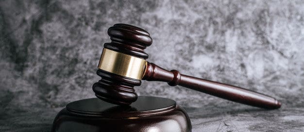 Wooden judge’s gavel representing Texas landlord-tenant law and lease termination legal process.